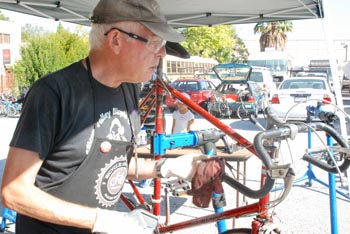 Man in work apron repairing a bicycle
